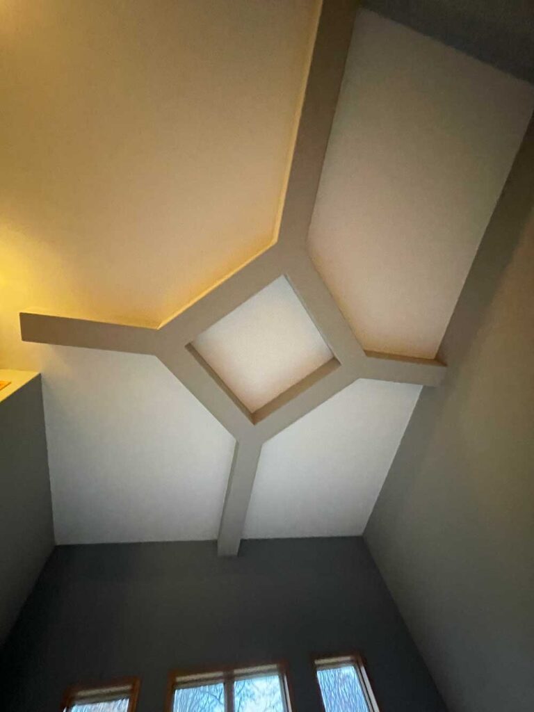 A room with a ceiling and walls that are white.