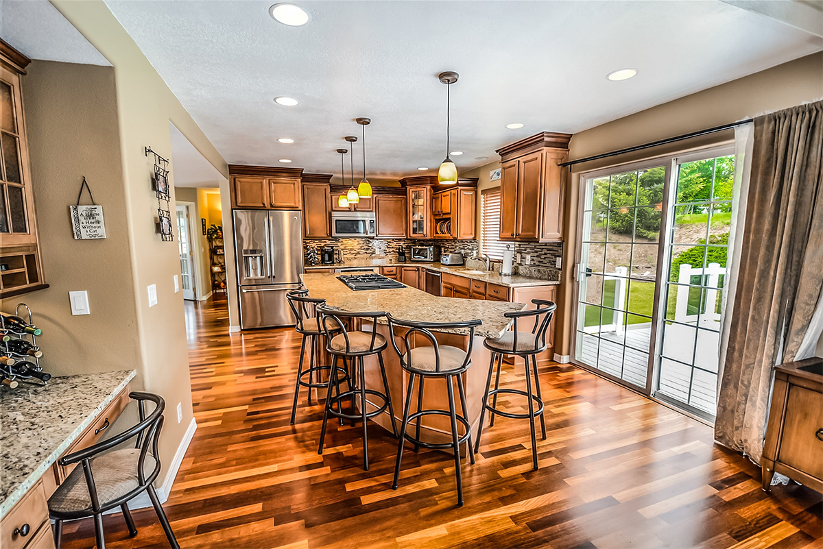 A kitchen with wooden floors and cabinets