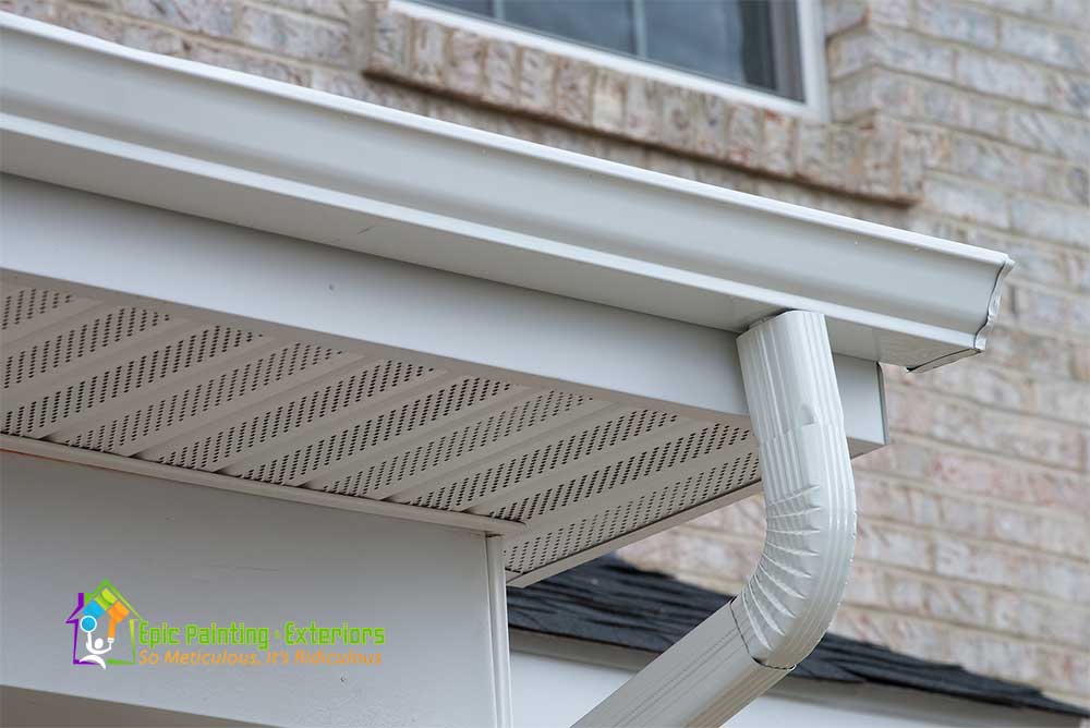 A white gutter on the side of a house.