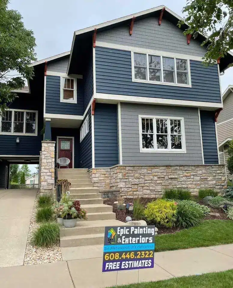 A house with blue siding and stone steps.