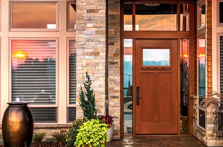 A front door of a house with plants and flowers.