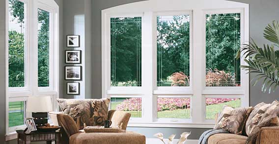 A living room with two windows and a couch