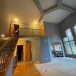 A large open living room with stairs leading to the second floor.